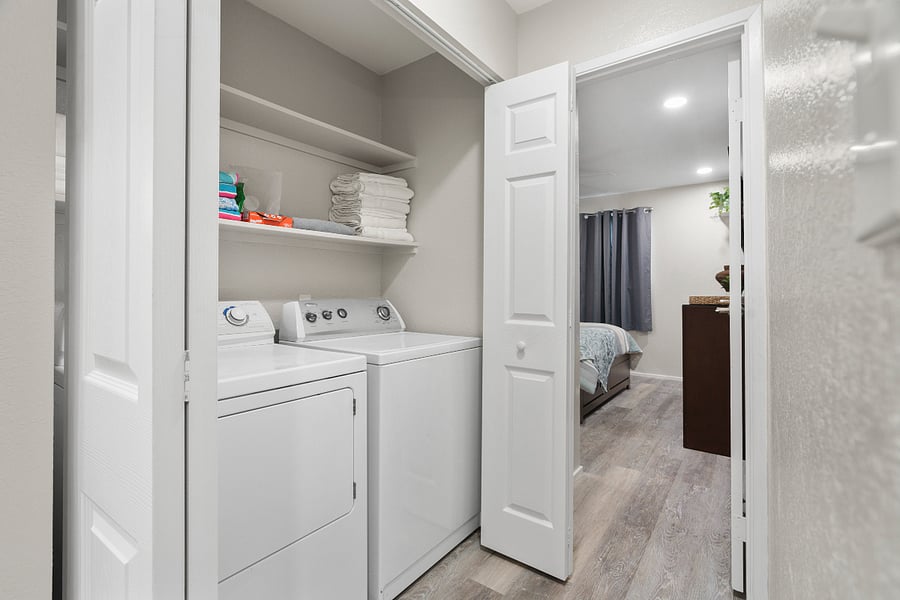 Closet in hallway between bedrooms. Full size washer and dryer.