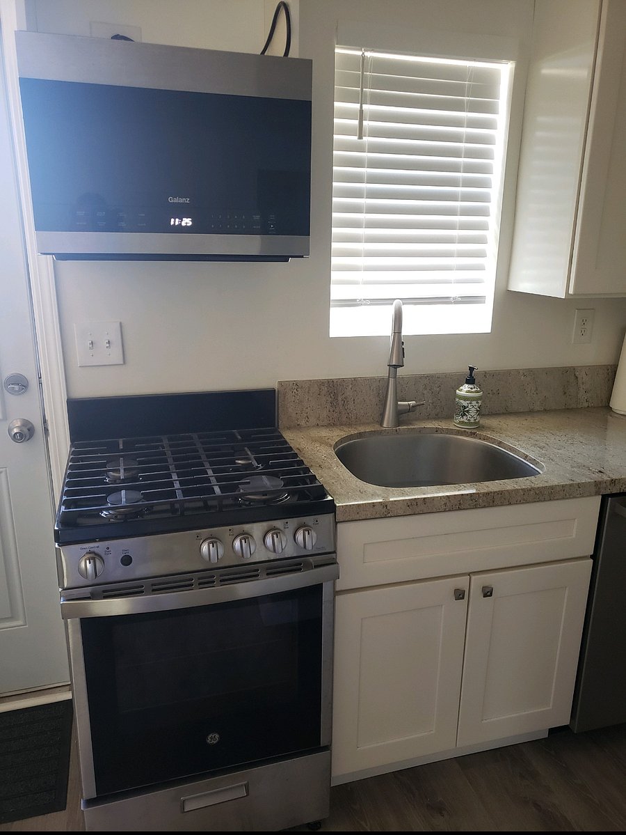 Gas range, microwave & deep sink.