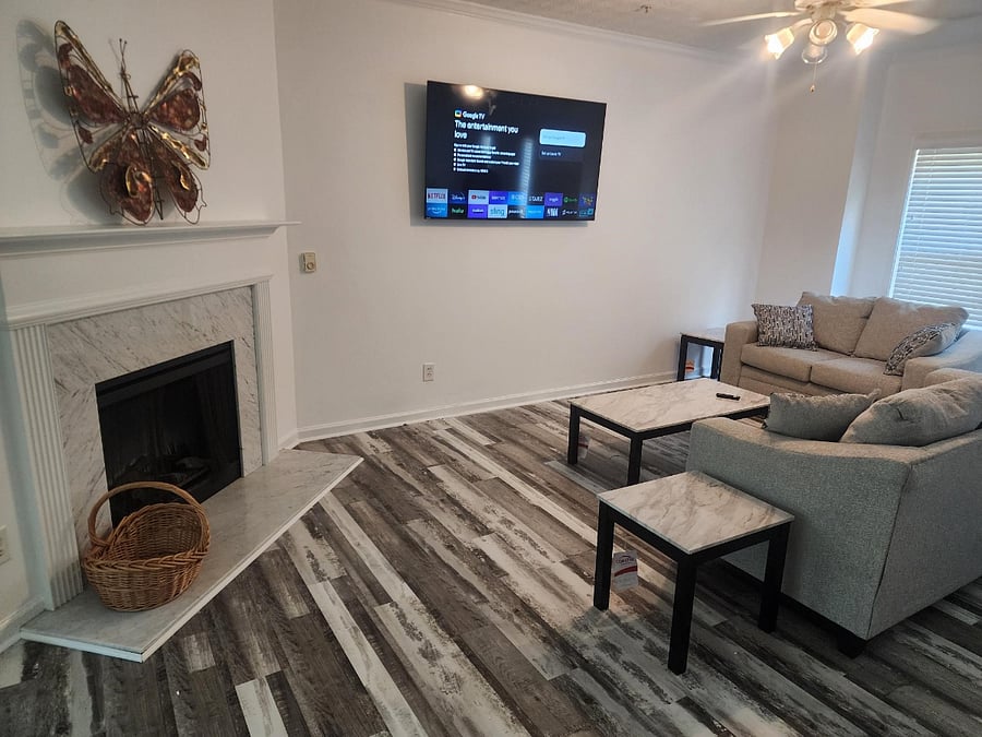 Comfy living area open concept with fireplace.