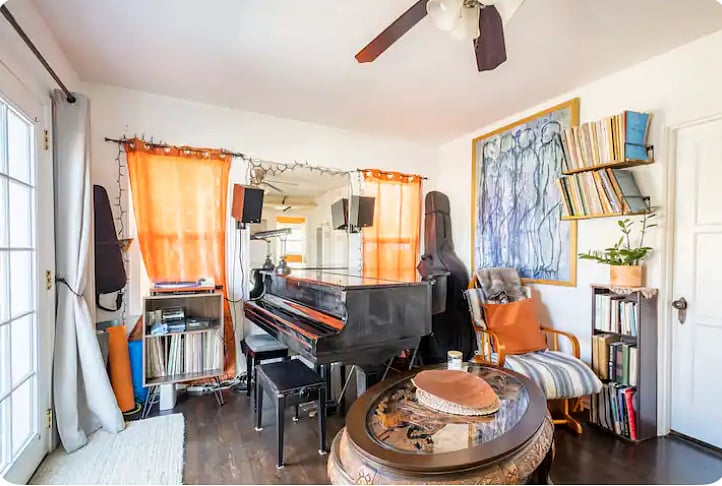 There is a record player, a grand piano and rocking chair. Instruments in the corners are no longer there.