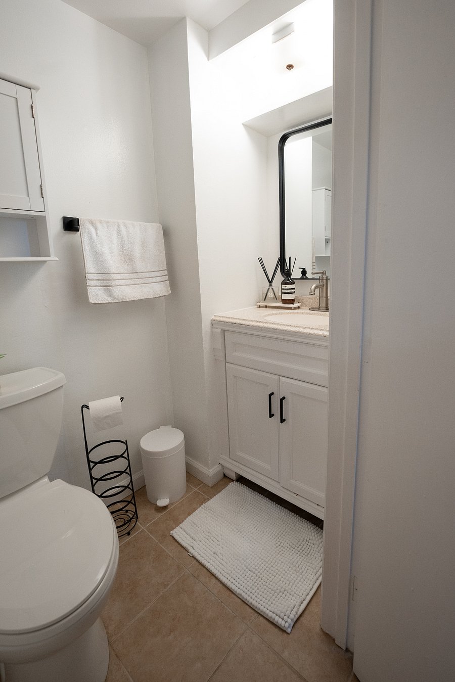 Modern bathroom with walk-in shower and updated fixtures. Linens and essentials provided.