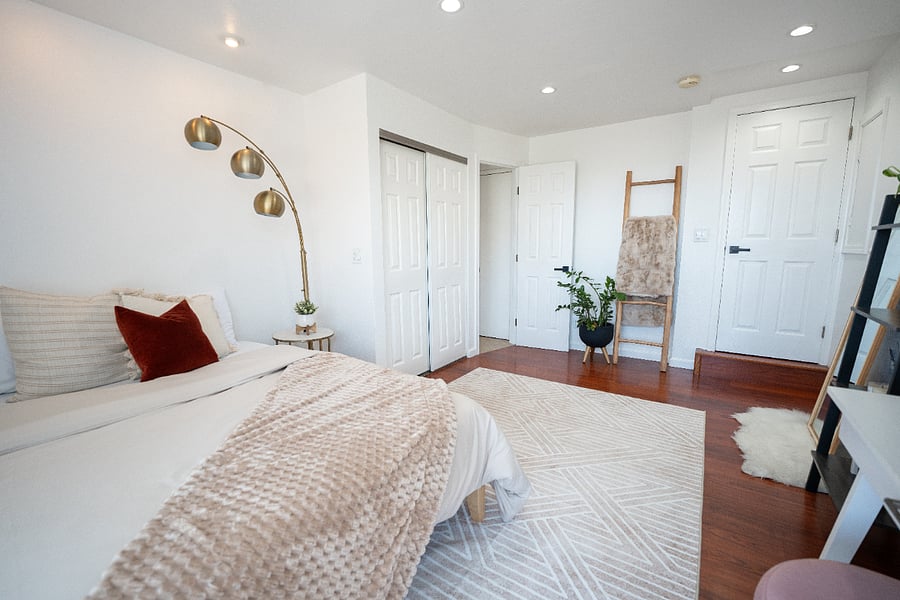 Naturally bright bedroom with large windows and privacy blinds. A calm, airy space to recharge between shifts or workdays.