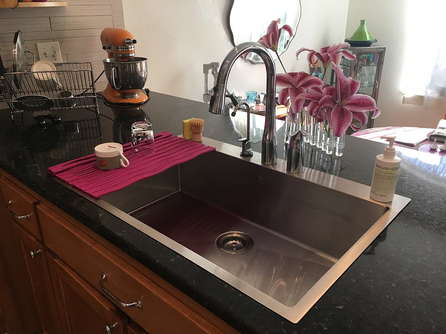 updated kitchen with stainless appliances, fully stocked for any chef