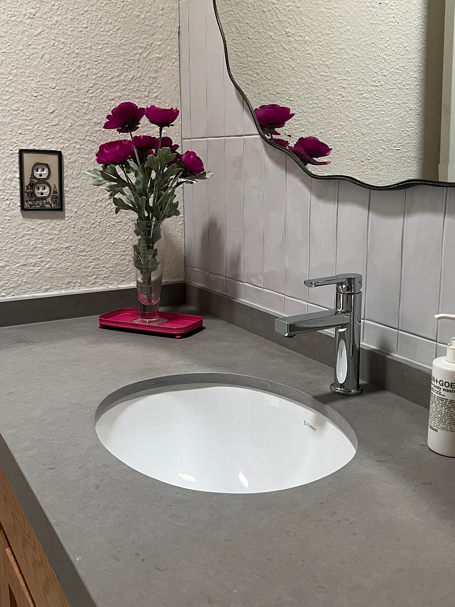 Newly renovated bath with designer hardware, specialty tile.