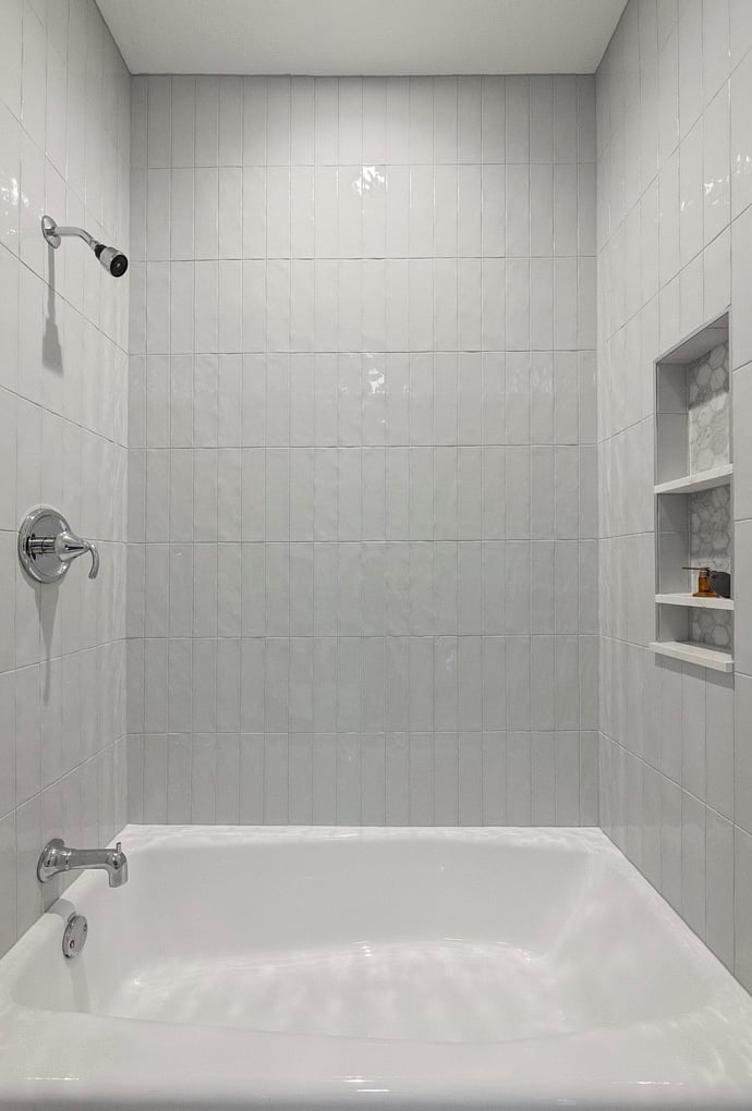 Floor to ceiling specialty tile in shower bath. 