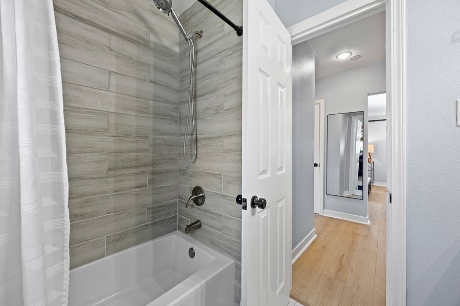 Newly renovated bathroom with full tub + shower.