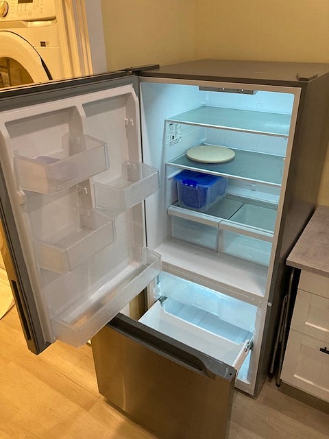 Full-sized Refrigerator w/Freezer Drawer and food storage containers.