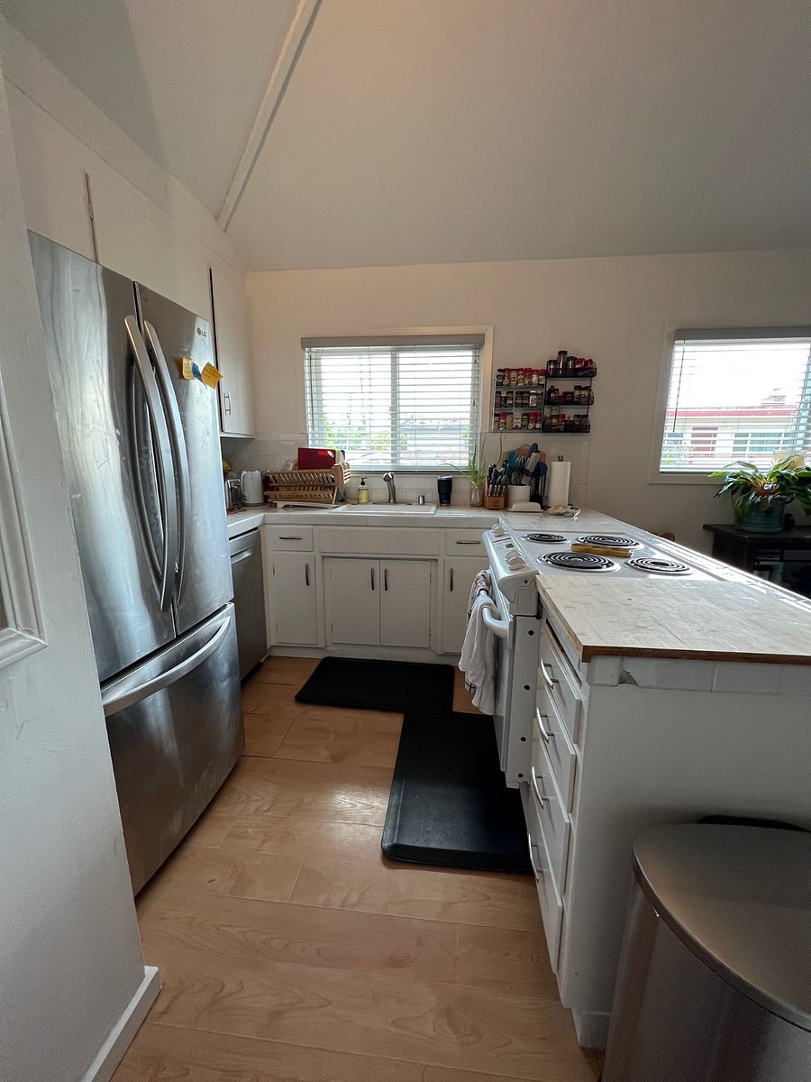 Full kitchen with appliances, utensils and kitchenware.
