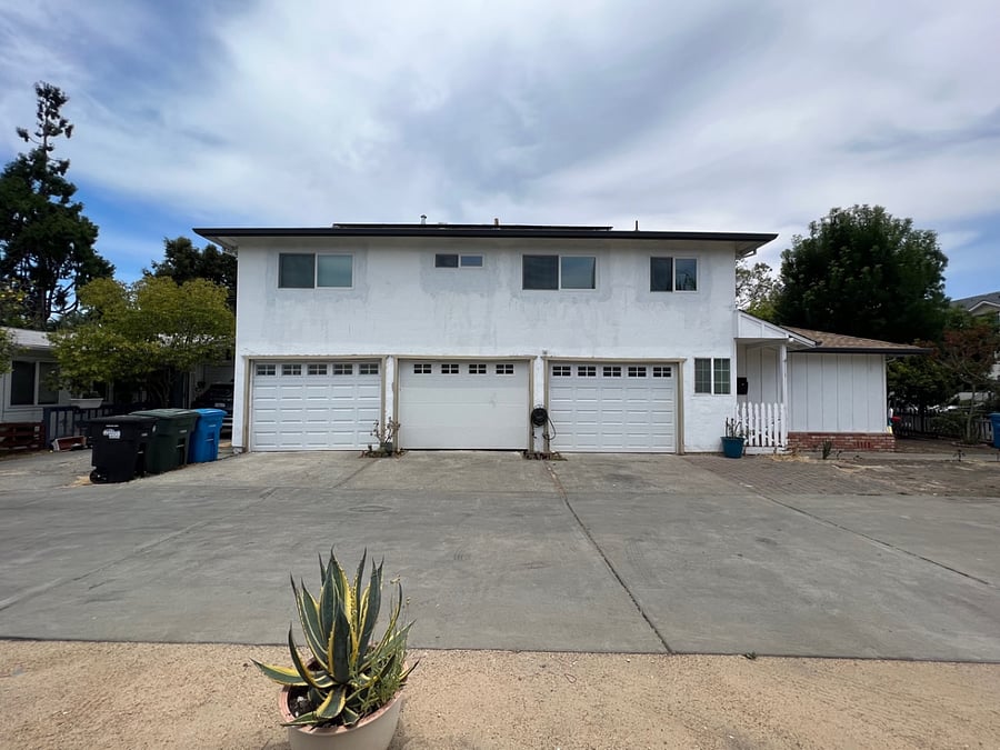 Exterior view of the property. The two garage doors on the left are our garage spaces. Can park in front of garages as well as across the court on dirt area,