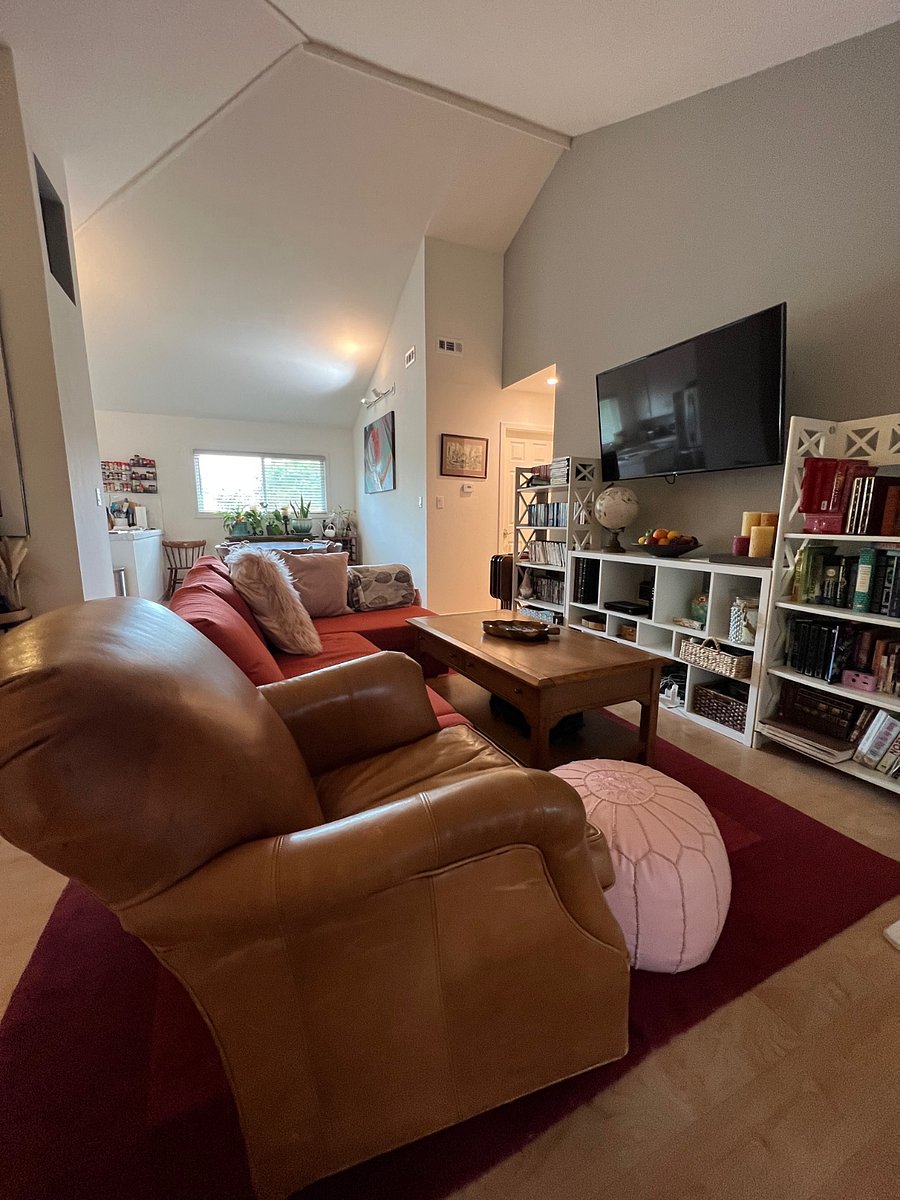 Angle of the TV room with eating area in background.