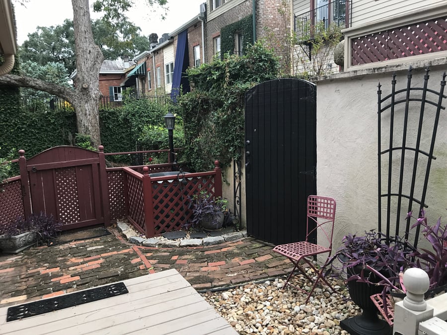 View from rear foyer toward adjacent driveway (behind gate)