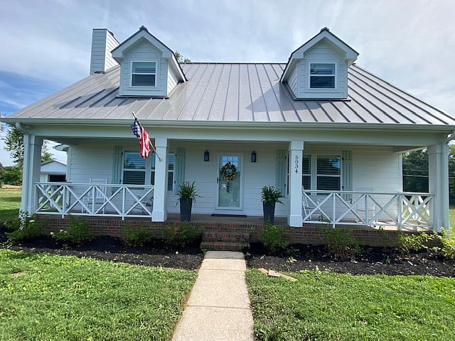 The inviting covered front porch is perfect for a cup of hot coffee or cocoa. Grab a book and stay a while...