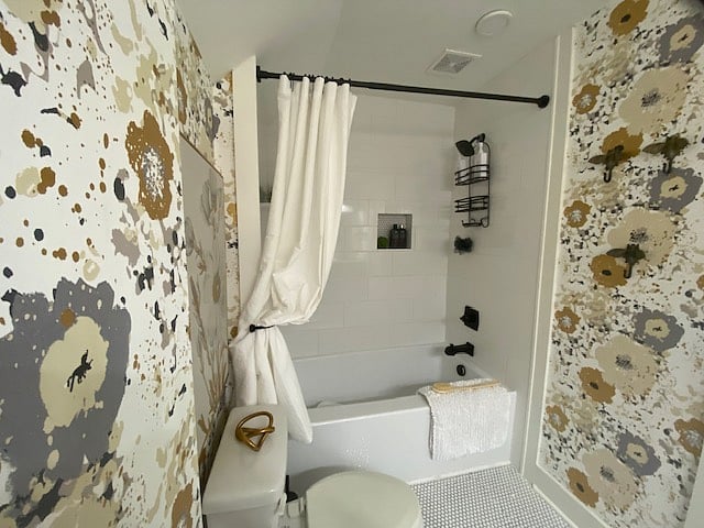Upstairs full bath features a shower/tub combo and double sink vanity.