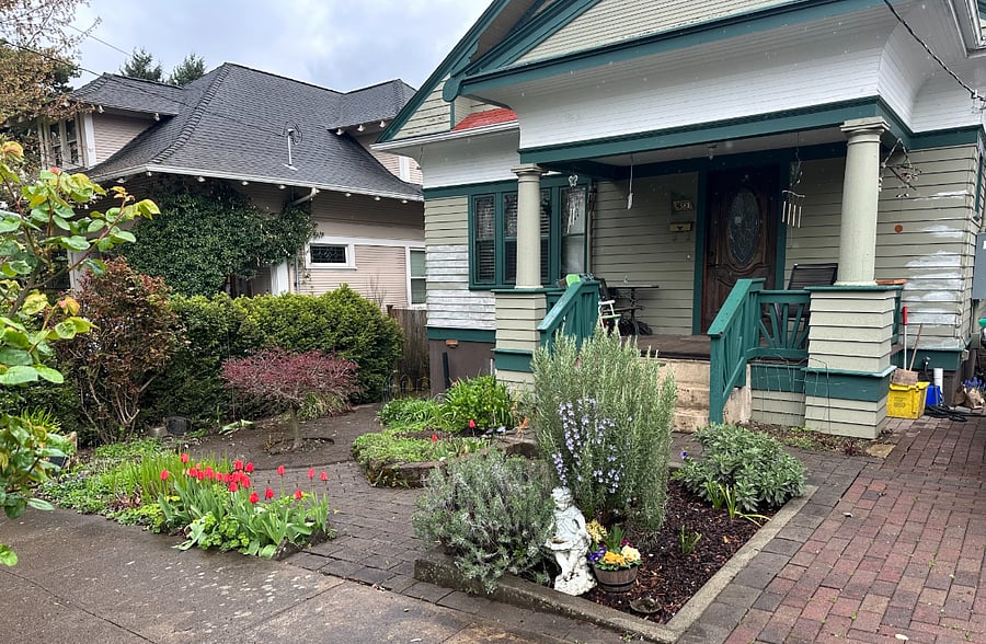 Front of house with spring growth just starting to pop up.