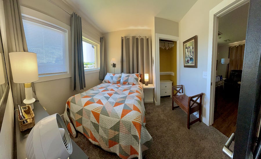 Full size bed, fan, bench, reach in closet, luggage rack.