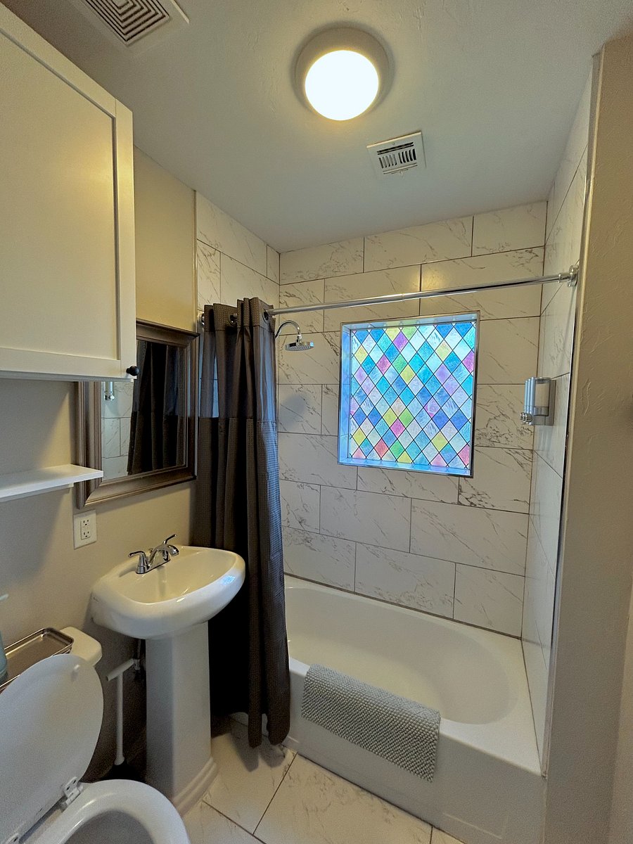 Full size shower and tub with upgraded linens and toiletries.