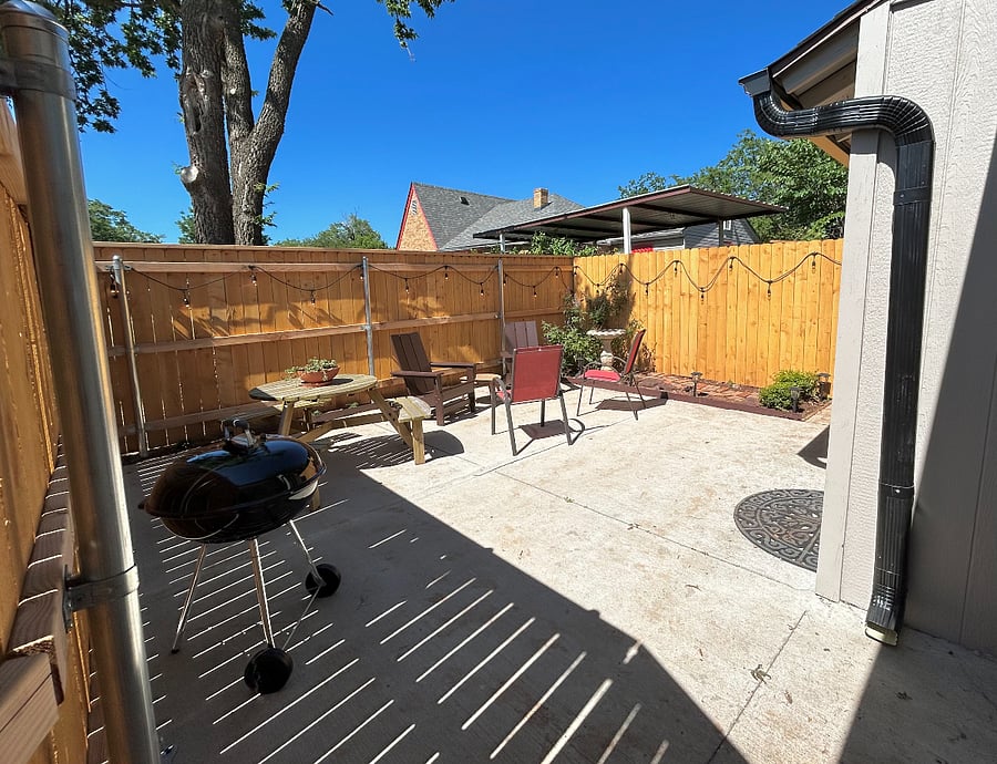 Private courtyard with driveway access and lockable walk-through gate. Plenty of comfortable seating and charcoal grill. String lights for evening enjoyment.