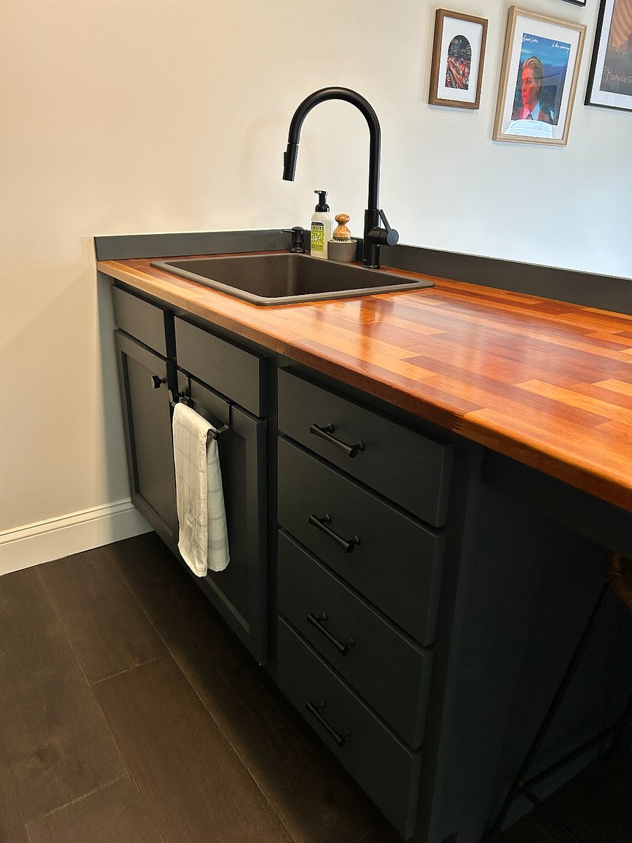 Kitchenette area with stools under countertop 