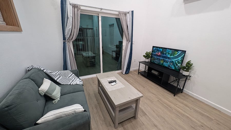 Living room area with access to private patio