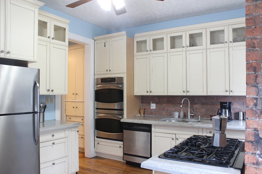 Kitchen with double ovens and 5 burner gas range.
