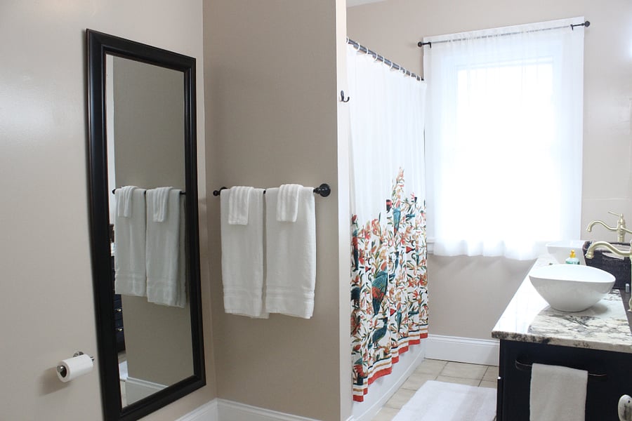 The bathroom features a double vanity sink so separate guests can have their own sink. There is a ventilation fan provided here.