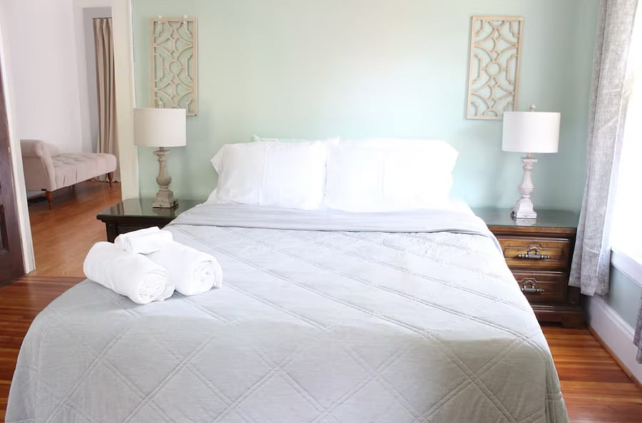 The second bedroom features a queen size mattress, a walk-in closet, an illuminated armoire, and a sitting area.