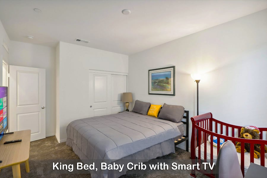 King bed with a baby crib, perfect for families traveling with little ones.
