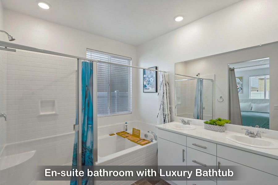 En-suite bathroom complete with a relaxing bathtub for your comfort.