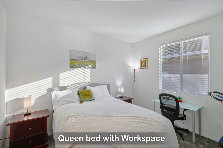 Queen bed with a dedicated workspace, ideal for both relaxation and productivity.
