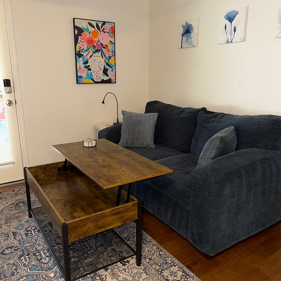 Coffee table top lifts to make a work space.
