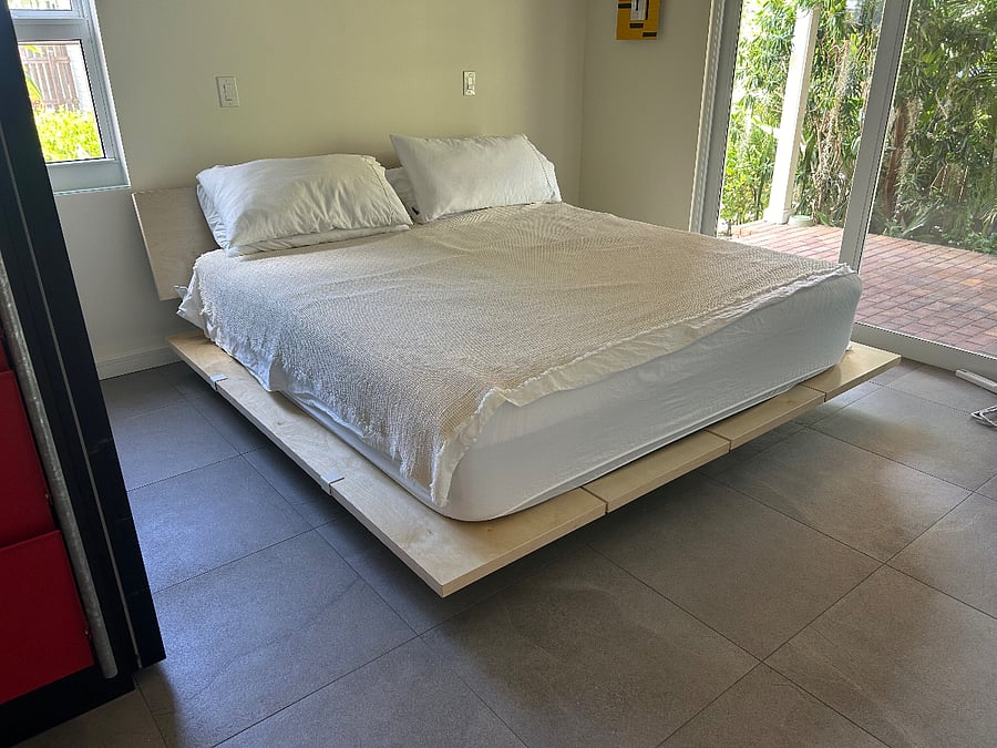 Bedroom with king bed looks out to wrap-around porch and plantings. Privacy and room-darkening shades.