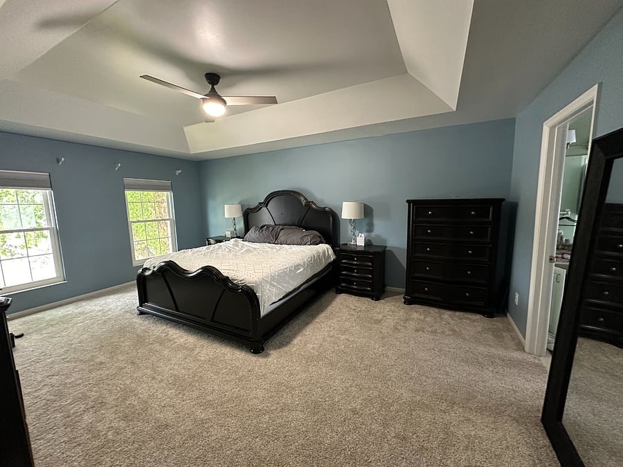 Oversized master bedroom with king size bed, 2 dressers, 2 endtables, and connected to master suite bathroom (not pictured) with jacuzzi tub, shower, private toilet, and walk in closet