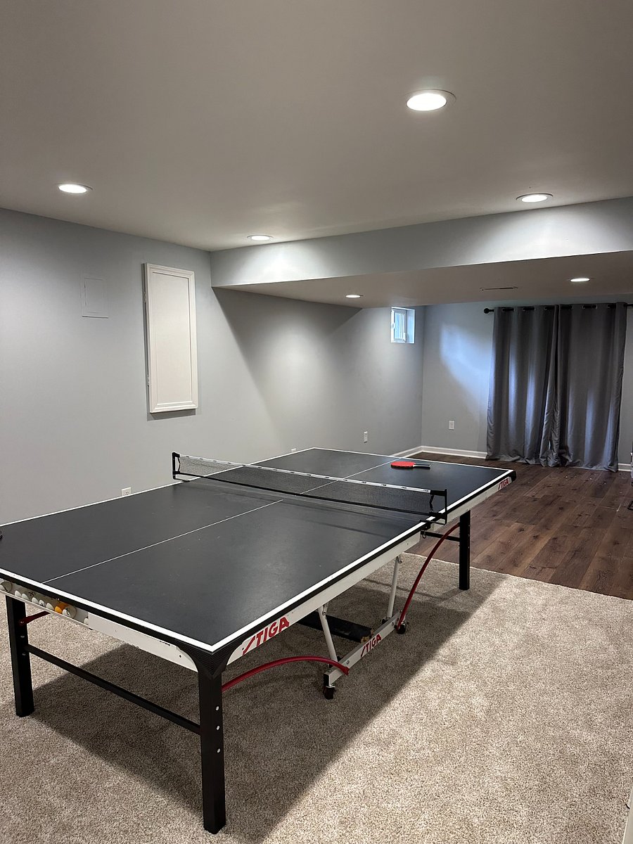 Basement ping-pong table and french doors to exit to pad with hottub (featuring new carpeting and new LVP flooring)