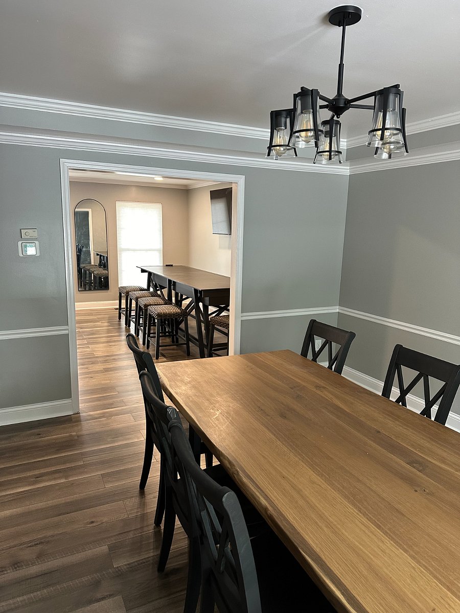 Dining room off the kitchen, connected to pub room. Dining room features beautiful wood table that can seat up to 10. Pub room features 55" smart TV, shuffleboard, and (not pictured) bar/liquor shelving and storage