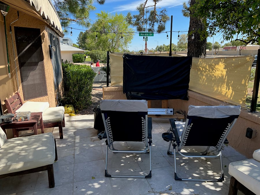 South view of rear patio, fireplace, TV, chairs, light string, privacy screen available. 
