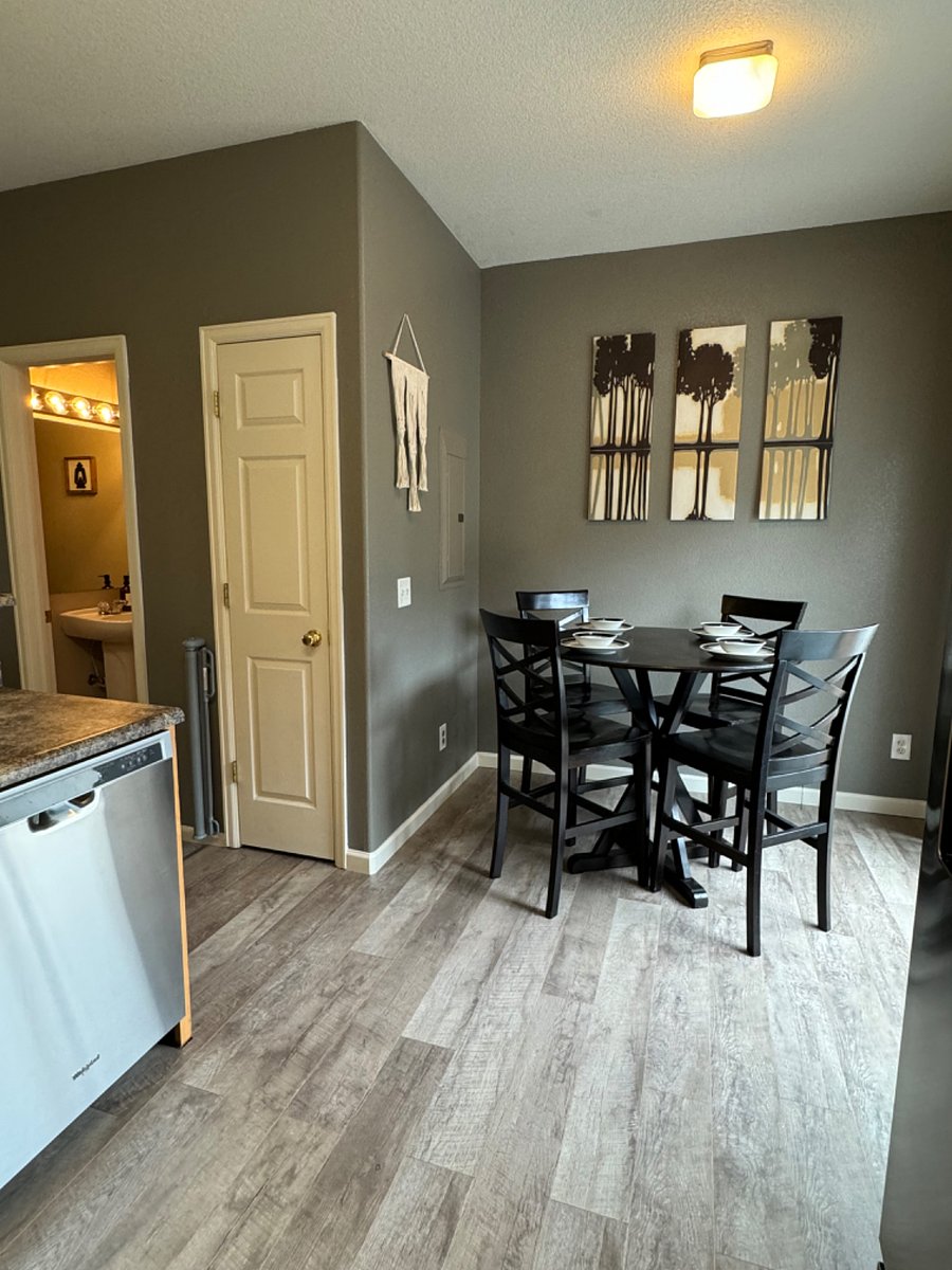 Full 4 chair dinning table right next to the kitchen