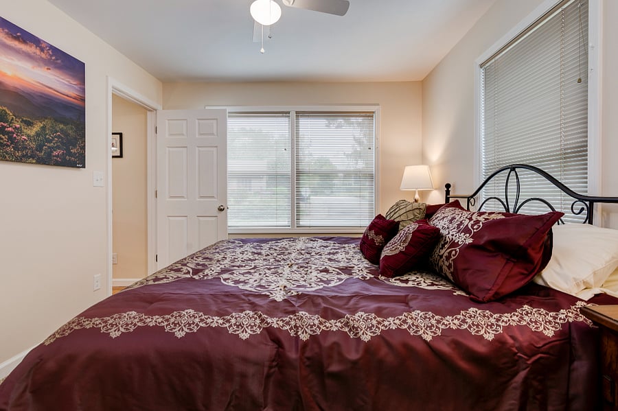King bed and tv in primary bedroom with ensuite bath