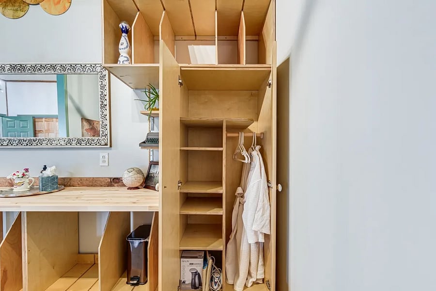 Small closet with storage. Includes iron & steamer.