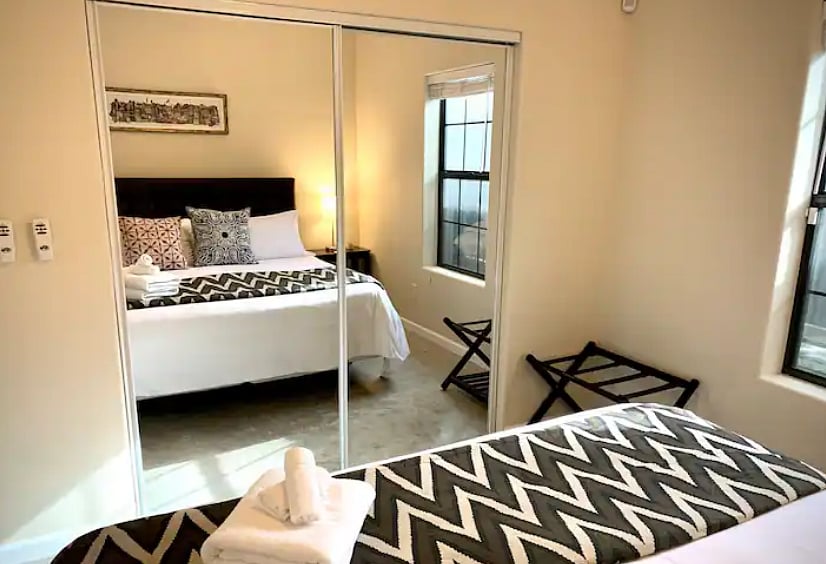 Full-size closet with mirror sliding doors.
Wood hangers and small pull-out bins for storage provided.