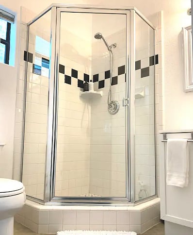 Bathroom shower includes a handheld wand for added comfort and convenience.