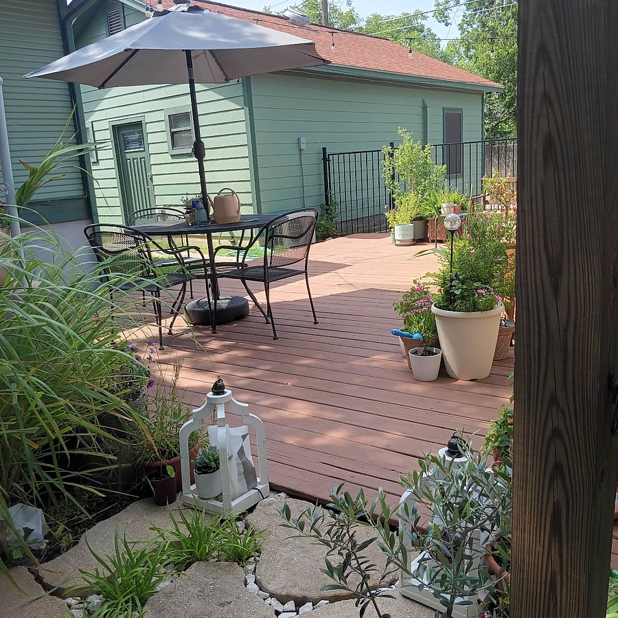 Guest House sits behind the main house. This photo shows the front entrance of the guest house. It also shows the backyard deck, available for guest's use. It