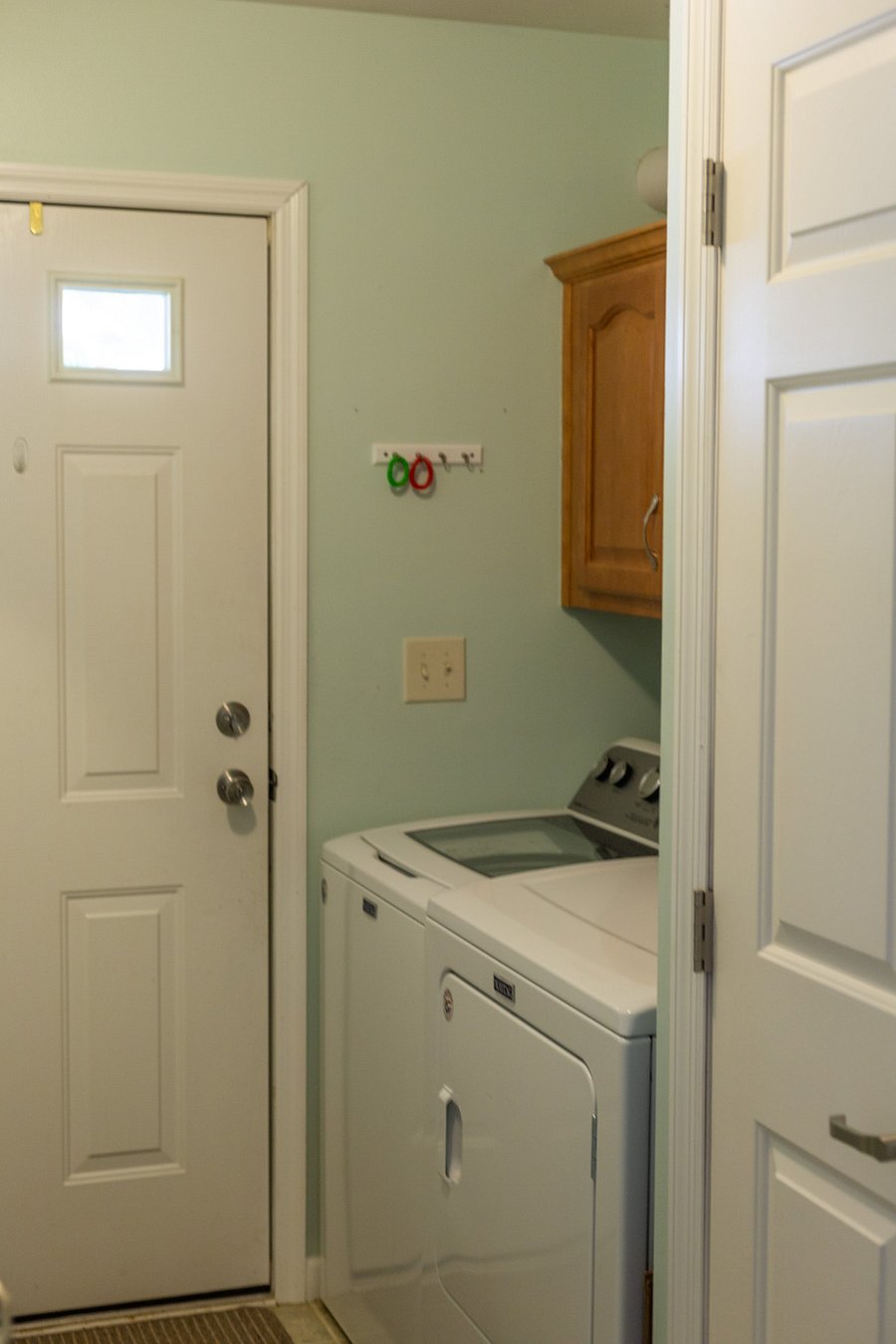 Mudroom with washer and dryer, adjacent to bedroom and bathroom