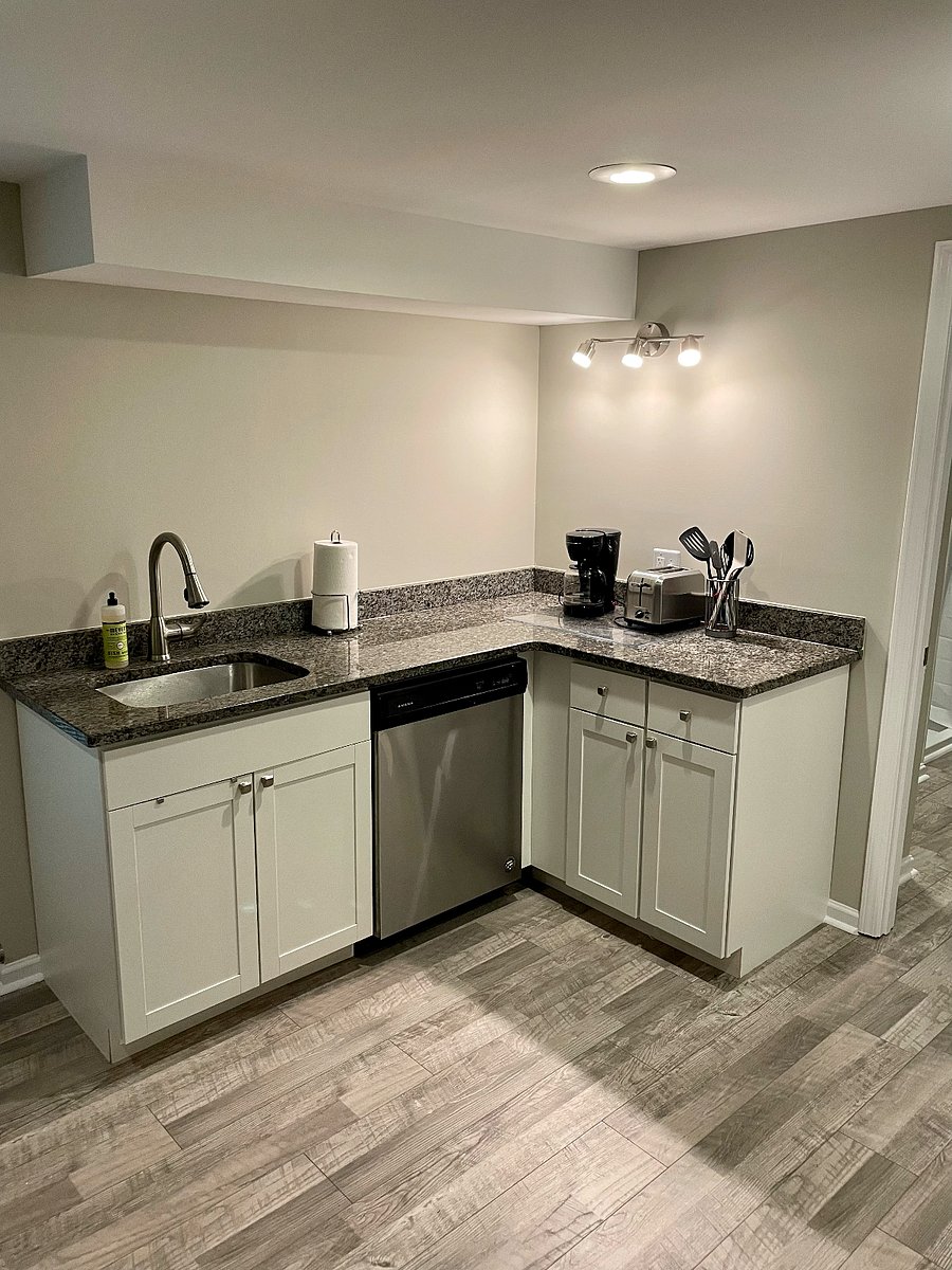 Kitchen area with dishwasher, microwave, full refrigerator, accessories included. No oven, however, stove top is provided.