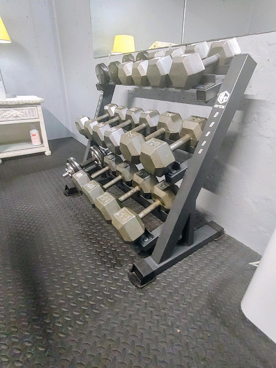 Work out room with weights, exercise equipment and a tanning bed located just outside the apartment entrance.