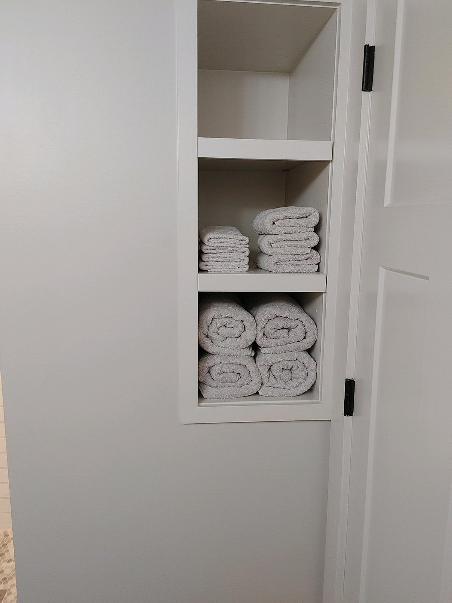 Bathroom storage behind the door.