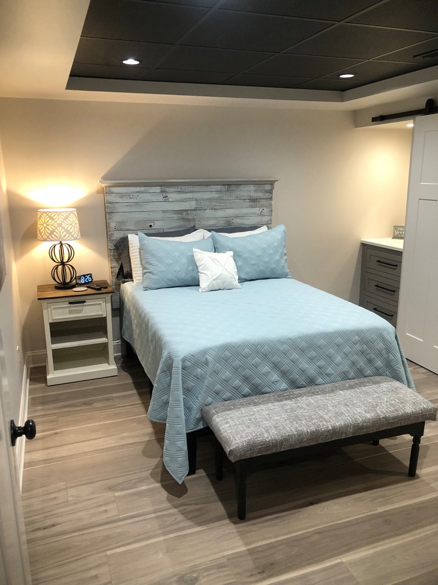 Front bedroom with trey ceiling and built in dressers.