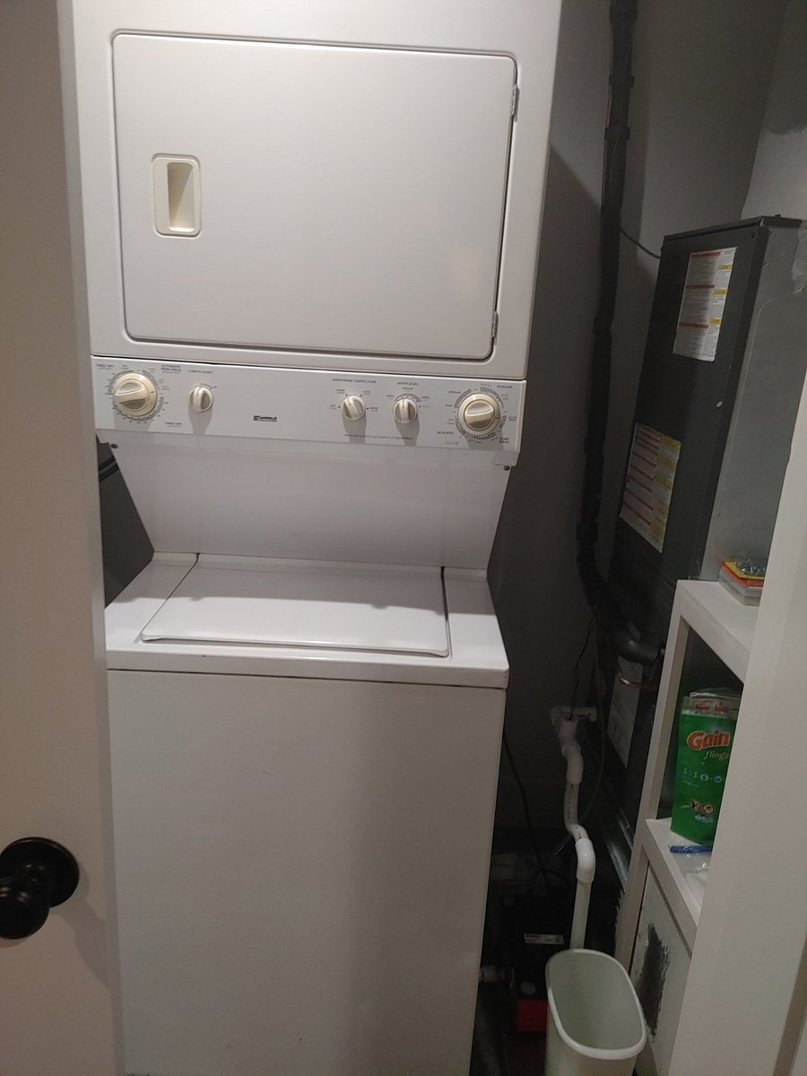 Laundry located in hallway between living room and bathroom.