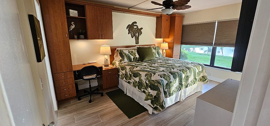 Entrance from main living area into the master bedroom with a king bed. Enjoy the designated work space and plenty of storage for your belongings