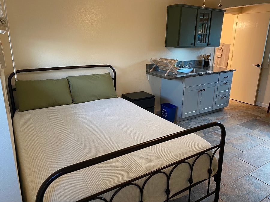 Queen size bed SW corner of studio