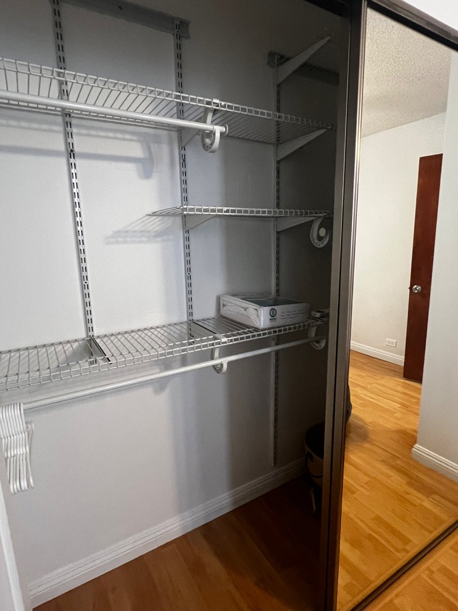 shelves on both sides of bedroom closet with enough room to hang clothes
